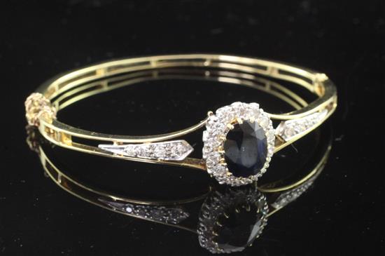 A mid 20th century gold, sapphire and diamond hinged bangle,